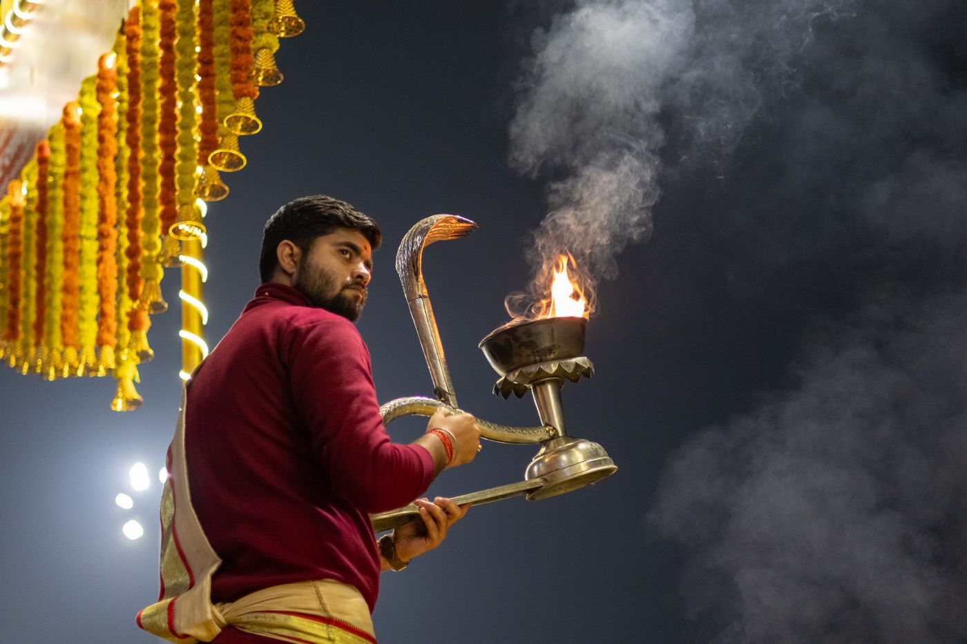 A priest performing rituals before a temple deity