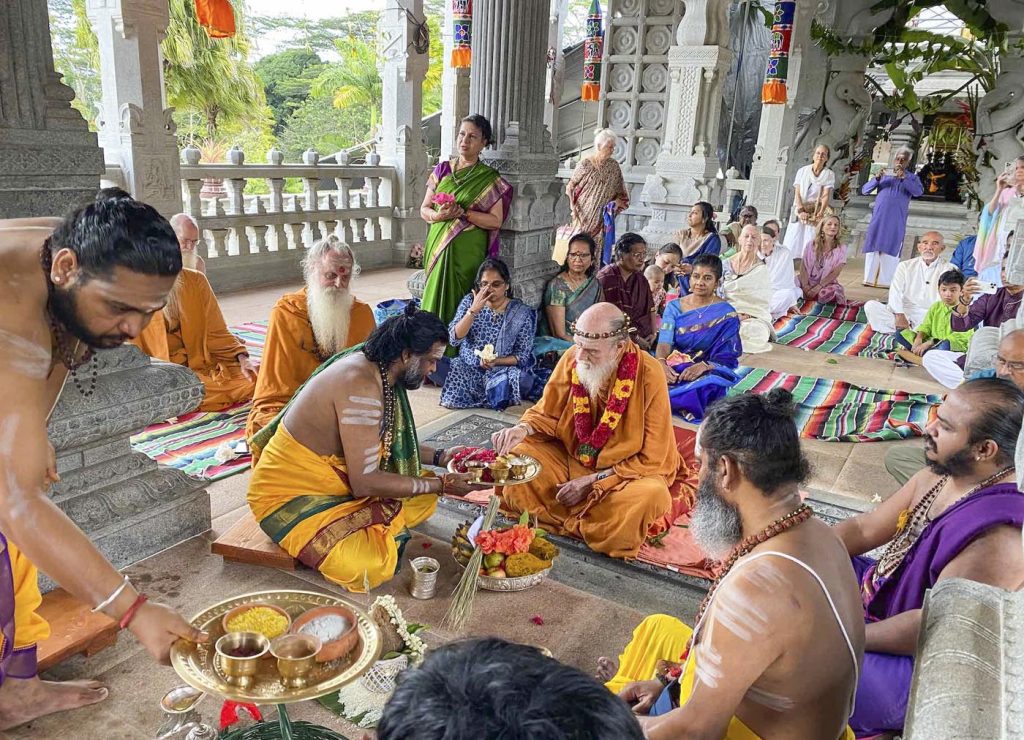 A temple consecration ceremony with priests and devotees gathered